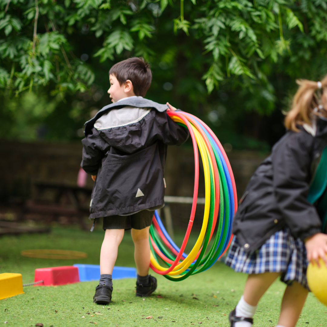 Reception pupil playing in the school garden